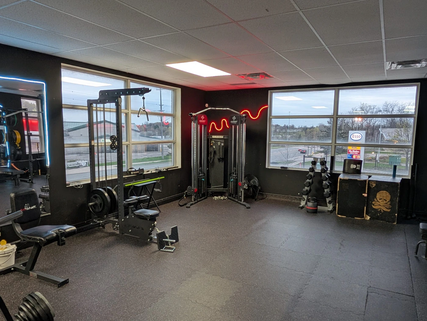 Cable station and free-weight corner at Retraine, a private gym in Pickering, Ontario.